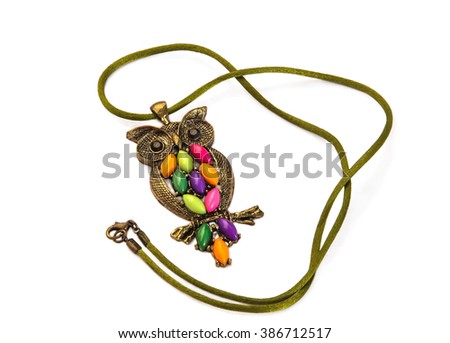 Owl necklace adorned with colored stones on a silk cord isolated over white.Main colors: green, pink, violet, orange.