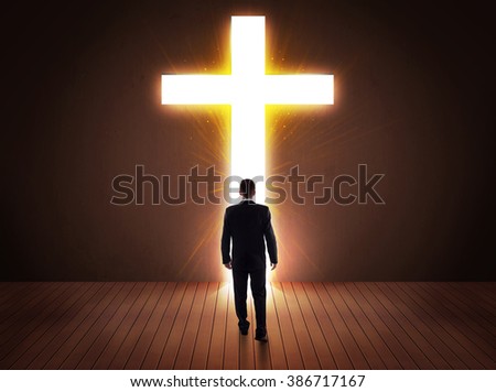 Man looking at bright cross sign concept