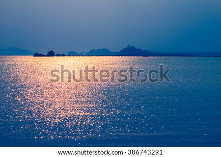 Scintillating sun light on sea water and bridge for background