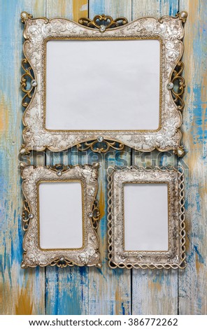 Vintage picture frame with white blank space inside for adding text on colored wooden background