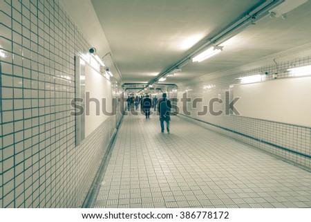 Blank billboard and people walking in underground subway, useful copy space for advertisement copy space