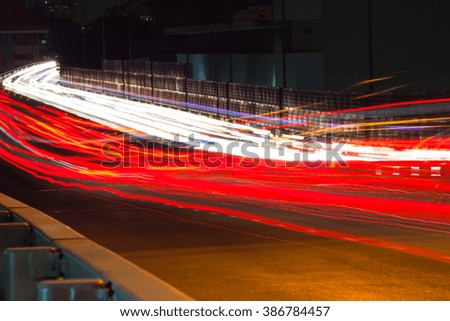 Abstract image of the light trails in night traffic in the city. Speeding concept