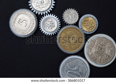 Coins gears on a black background. business concept