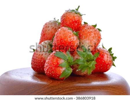 an old wooden bowl filled with succulent juicy fresh ripe red strawberries on top
isolated on white background

