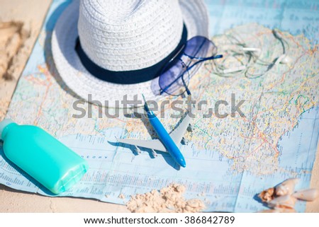 Passport, ticket, phone on a background map of the world. Traveling concept
