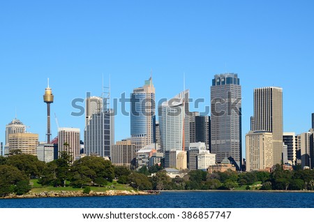 View from water on the sydney cbd with sydney tower and skyscrapers and royal botanic garden with tourists Royalty-Free Stock Photo #386857747