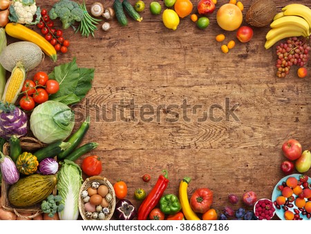 Organic food background. Studio photo of different fruits and vegetables on old wooden table. High resolution product.