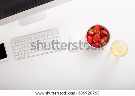 Strawberries and lemon water in office setup 