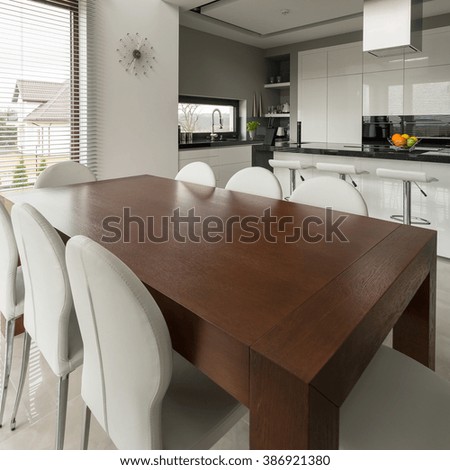 Big wooden dining table in modern expensive kitchen