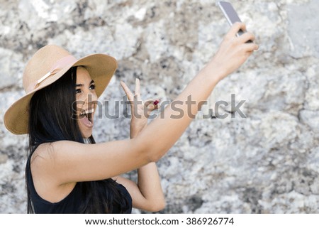 Beautiful girl taking a selfie and having a good time during summer