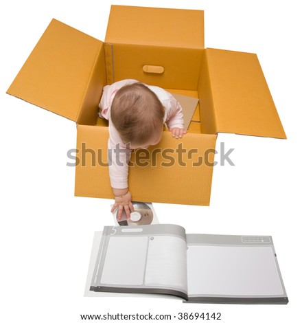 Baby in a box. Reaching out for the setup disk and instructions.
