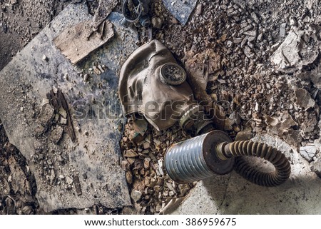 Old Dirty Gas Mask Lying On Messy Industrial Ground