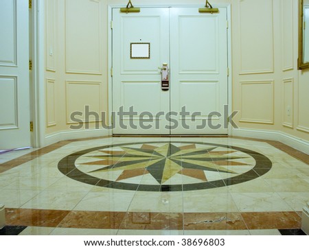 Anteroom with white double door and mosaic marble floor