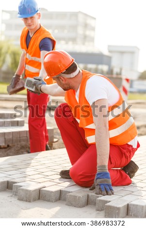 Picture of busy road worker making new pavement