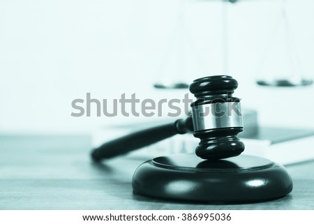 Wooden judges gavel on wooden table, close up. Retro stylization