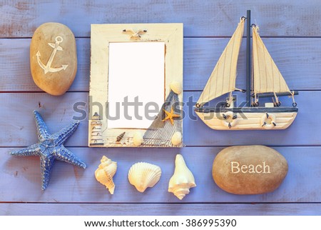 wooden nautical frame and sailing boat on wooden table. nautical lifestyle concept. template, ready to put photography
