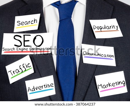 Photo of business suit and tie with SEO conceptual words written on paper cards