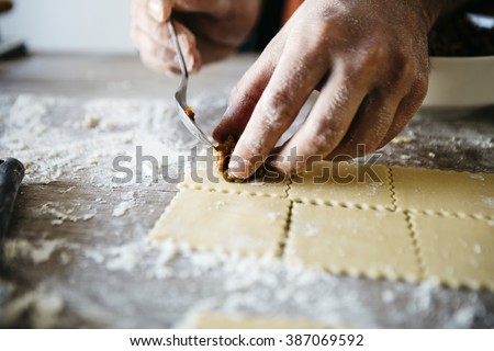 Man making ravioli, Italian cuisine and gluten-free Royalty-Free Stock Photo #387069592