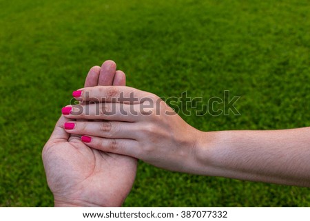 Girls holding hands lawn green