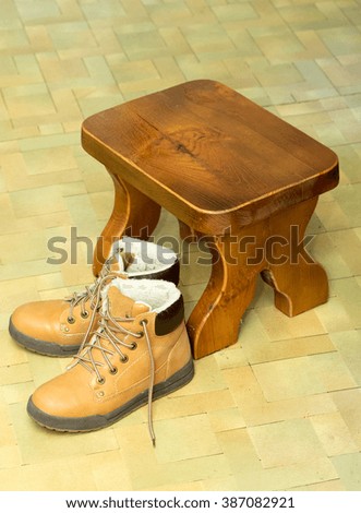 yellow shoes on the floor with a stool
