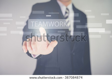 Hand pressing modern multimedia teamwork type buttons on network concept structure,Businessman 