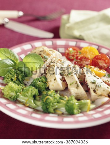 Stuffed Chicken breast served with broccoli and tomatoes.