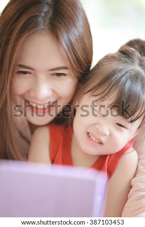 Beautiful asian Mother and Daughter taking selfie