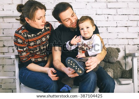 Smiling family with pretty child having fun at home