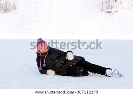 girl in bright pink hat and in the skating rink lies on its side on
	
