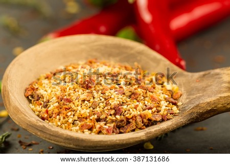 Red hot chili pepper on vintage black table. Colorful dried natural herbs and spices.