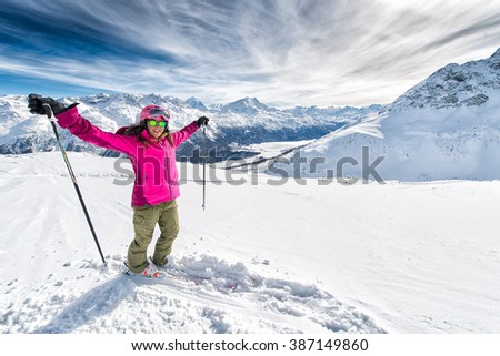 Ski, beautiful and young skier girl enjoying winter vacation to St. Moritz.