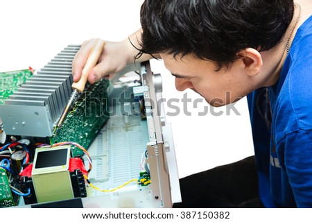 engineer engaged in the repair of complex electronic devices