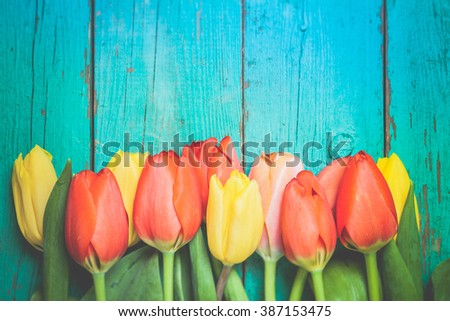 Toned photo. Color tone tuned. Fresh red tulip flowers bouquet on wood. Natural spring or Valentine's Day, Mother's Day theme.  Royalty-Free Stock Photo #387153475