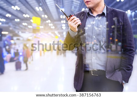 Double exposure of Security Officer use Radio with Blur airport background  Royalty-Free Stock Photo #387156763