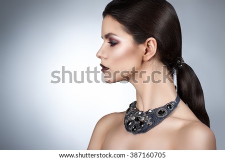 style woman portrait perfect face, professional make. fashion mouse with big ears. Fashion art photo. The girl holds a finger near lips