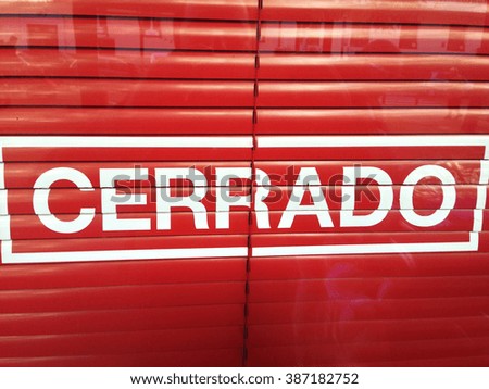 Closed sign in spanish. Shop showroom with reflections