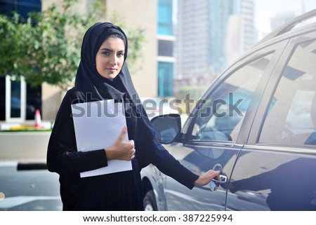 Emarati Arab Business woman getting inside the car in Dubai, United Arab Emirates.