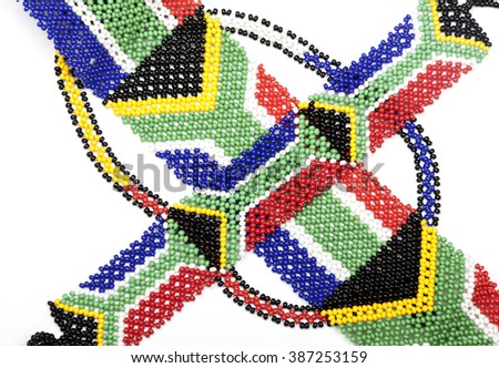 Close up studio shot threaded bead work in the colors of the south african flag on white