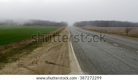 The road leading into the dense fog