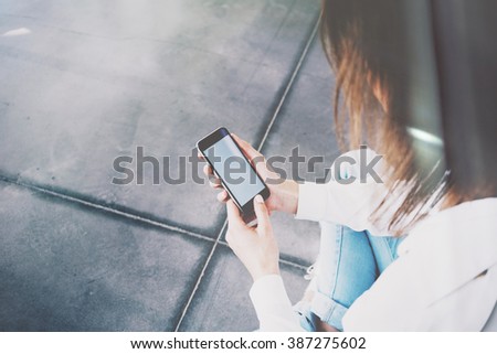 Photo of woman typing text message smartphone. Film effects, blurred background. Horizontal