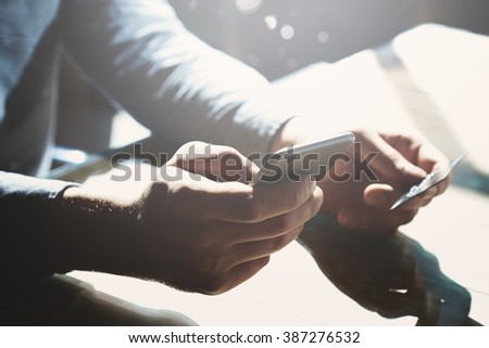 Businessman holding hand credit card and using smartphone. Online banking. Horizontal mockup. Blurred, film effect