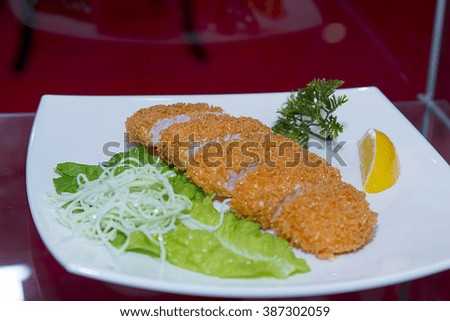 Fried chicken with a side dish of green