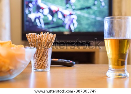TV, television watching (American football match) on TV with snacks and alcohol - stock photo