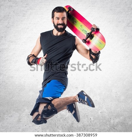 Skater jumping with thumb up