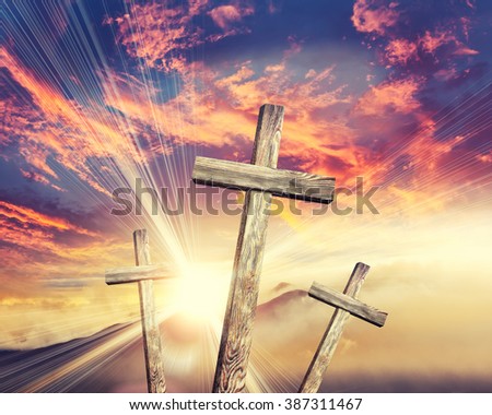 Old brown wooden cross, with sun flash 