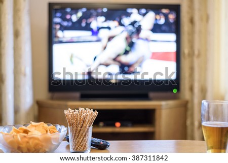 TV, television watching (wrestling match) on TV with snacks and alcohol - stock photo