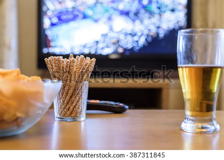 TV, television watching (wrestling match) on TV with snacks and alcohol - stock photo