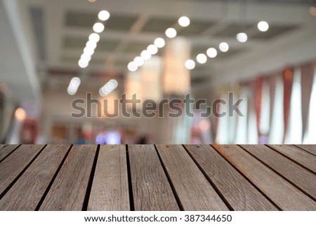 blurred image wood table and abstract of long corridor