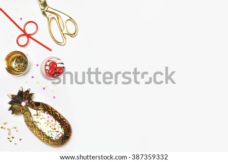 White mock up background, flat lay. Gold accessories on table. View up, gold items stationery. Feminine scene, workspace. Gold pineapple, confetti, strawberry. Party background, Drink and eat.