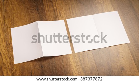 Bifold white template paper on wood texture Royalty-Free Stock Photo #387377872